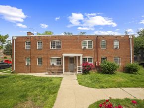 Washington apartment for rent - A red brick building with a white door and windows.