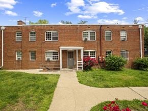 Washington apartment for rent - A red brick building with a white door and windows.