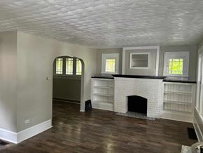 Akron house for rent - A room with a fireplace and a window.