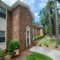 Fayetteville apartment for rent - A brick house with a white door and a window.