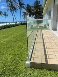 Hollywood apartment for rent - a glass railing on a patio next to a lawn and a house