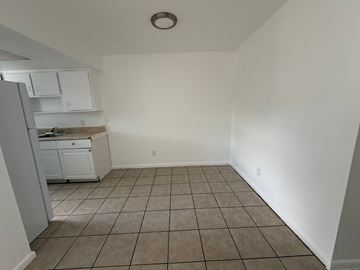 Vero Beach apartment for rent - A kitchen with white cabinets and a refrigerator.