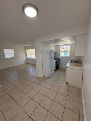 Vero Beach apartment for rent - A kitchen area with a refrigerator, sink, and a window.