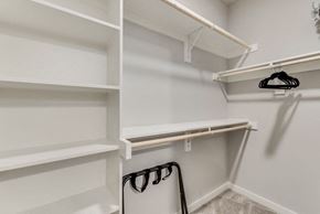Mckinney house for rent - a walk in closet with white shelving and white walls and a white closet door