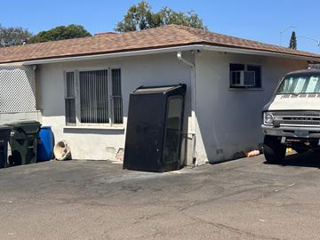 Vista apartment for rent - a refrigerator sitting outside of a house next to a car