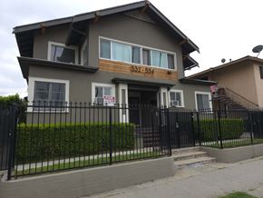Los Angeles apartment for rent - A two-story house with a black fence in front.