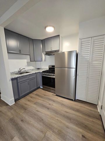 Los Angeles apartment for rent - A kitchen with a stainless steel refrigerator and wooden flooring.