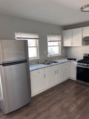 Los Angeles apartment for rent - A kitchen with a stainless steel refrigerator, sink, and stove.