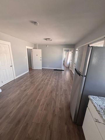 Los Angeles apartment for rent - A kitchen with a refrigerator and wooden floors.