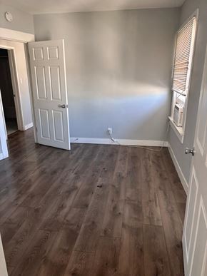 Los Angeles apartment for rent - A room with a white door and wooden flooring.