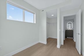 Kelowna apartment for rent - A room with a large window and a door leading to another room.