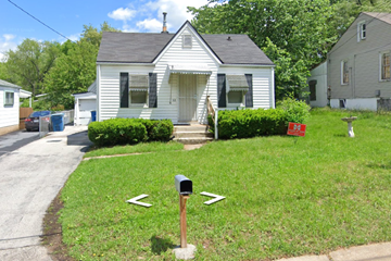 Saint Louis house for rent - a small white house with a mailbox in the front yard