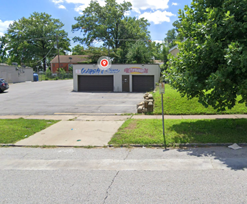 St. Louis house for rent - a parking lot in front of a car dealership