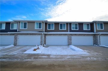 Waukee apartment for rent - an empty garage in front of a house with white doors