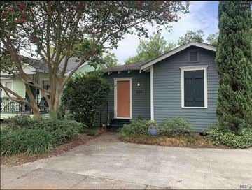 Baton Rouge house for rent - a blue house with a brown door and a driveway