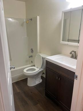 Everett apartment for rent - A white toilet with a sink and mirror in a bathroom.