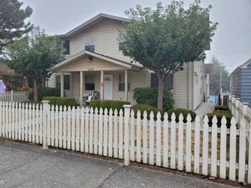 Everett apartment for rent - a white picket fence in front of a house