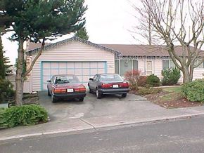 Everett house for rent - Two cars are parked in front of a house.