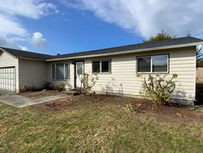 Everett house for rent - A house with a grey roof and a small garden in front.