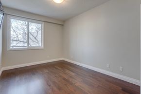 Edmonton apartment for rent - an empty living room with wood floors and a window