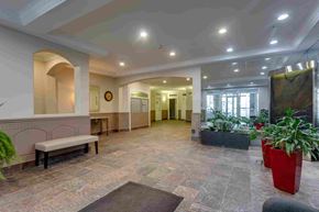 Edmonton apartment for rent - a lobby with a bench and potted plants