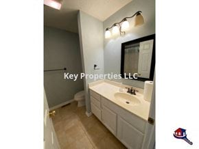 Loudon house for rent - A bathroom with a sink, mirror, and toilet.