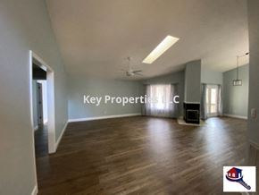 Loudon house for rent - A spacious room with wooden flooring and a ceiling fan is on the market through Key Property SLLC.