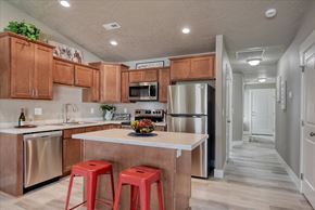 Spokane Valley apartment for rent - A kitchen with a white countertop and red stools.