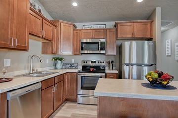 Spokane Valley apartment for rent - A kitchen with wooden cabinets and stainless steel appliances.
