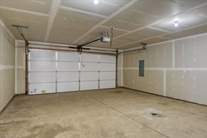 Spokane Valley apartment for rent - A garage with a white door and a concrete floor.
