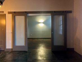 La Crosse apartment for rent - A room with a glass door and a light on the wall.
