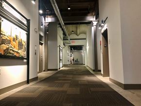 La Crosse apartment for rent - A long hallway with a carpeted floor and a painting on the wall.