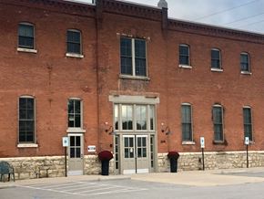 La Crosse apartment for rent - A red brick building with a grey door and windows.