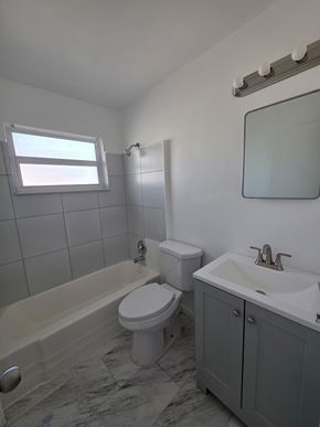 Vero Beach apartment for rent - A white toilet sits next to a bathtub in a bathroom.