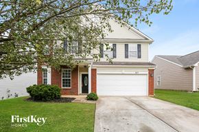 Monroe house for rent - a white house with a white garage door
