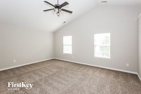 Monroe house for rent - a bedroom with carpet and a ceiling fan