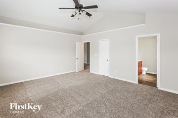 Monroe house for rent - a living room with carpet and a ceiling fan