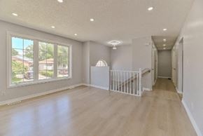 Belleville apartment for rent - an empty living room with a staircase and a large window