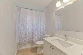 Belleville apartment for rent - a bathroom with a toilet and a sink and a mirror