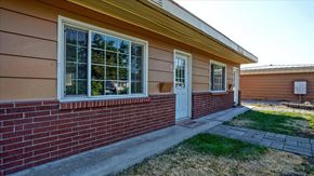 Spokane Valley apartment for rent - A house with a red brick wall and a white door.