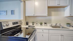 Spokane Valley apartment for rent - A kitchen with a stove, sink, and cabinets.