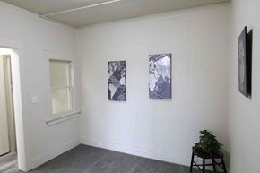 Spokane apartment for rent - A room with two paintings on the wall and a plant on a stool.
