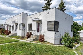 Spokane apartment for rent - A white house with a red door and windows.