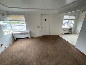 Spokane apartment for rent - A room with brown carpet and a white door.