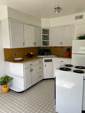 Spokane apartment for rent - A kitchen with white cabinets and a white refrigerator.