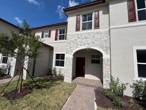 Miami Shores house for rent - a building with a walkway and a tree in front of it