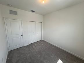 Miami Shores house for rent - a bedroom with white walls and carpet and two doors