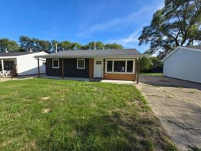 Gary house for rent - a home with a driveway and a lawn