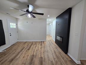 Gary house for rent - a living room with a wood floor and a ceiling fan