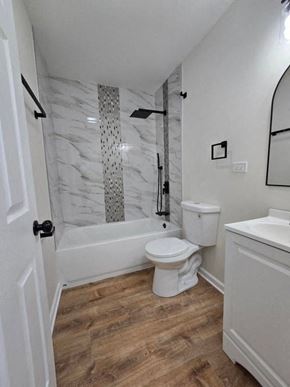Gary house for rent - a bathroom with a toilet and a tub and a sink